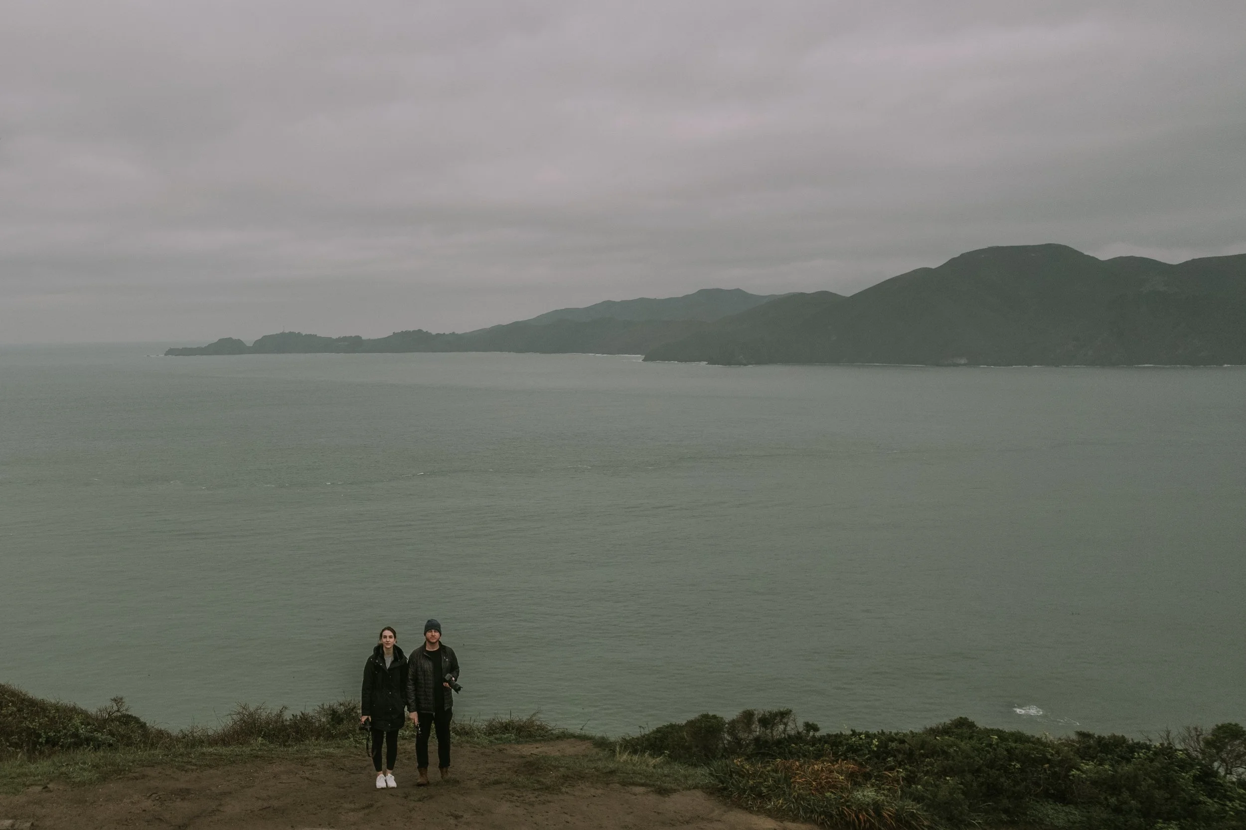 Karthik and Tira on a foggy headland above the Pacific near the Golden Gate, San Francisco